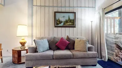 a living room with a couch with pillows on it at Mammoth Reservations in Mammoth Lakes