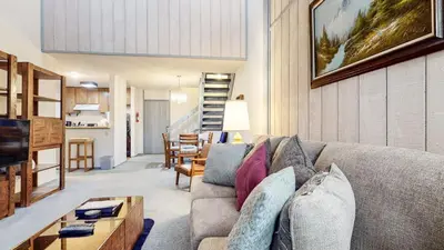 a living room with a couch and a table at Mammoth Reservations in Mammoth Lakes