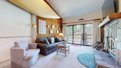 a living room with a couch and a fireplace at Mammoth Reservations in Mammoth Lakes