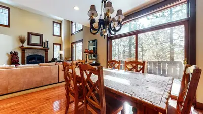 a dining room with a table and a couch at Timbers 1 Apartment in Mammoth Lakes