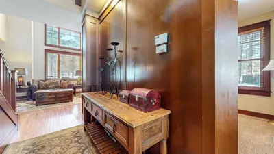 a living room with a table with a suitcase on it at Timbers 18 Apartment in Mammoth Lakes