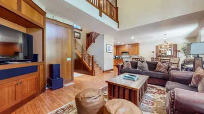 a living room with a couch and a tv at Timbers 18 Apartment in Mammoth Lakes