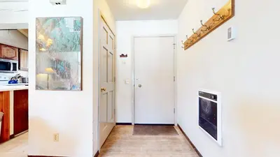 a hallway with white walls and a white door at Wild Flower 6 Apartment in Mammoth Lakes