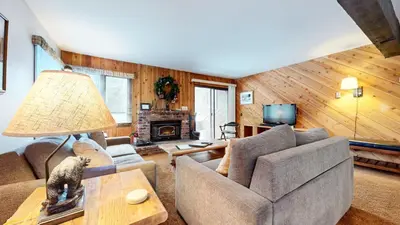 a living room with a couch and a table at Wild Flower 37 Apartment in Mammoth Lakes