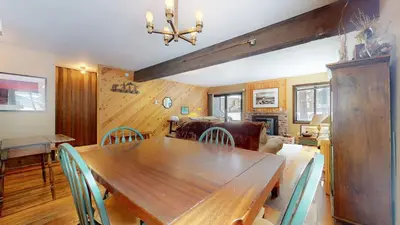 a dining room with a wooden table and chairs at Wild Flower 39 Apartment in Mammoth Lakes