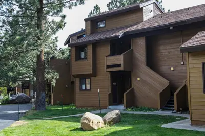 a house with two rocks in front of it at Wild Flower 39 Apartment in Mammoth Lakes