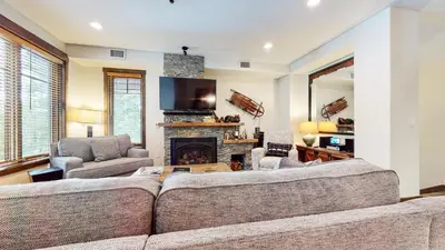 a living room with a couch and a fireplace at Mammoth Reservations in Mammoth Lakes