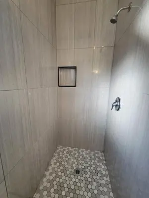 a bathroom with a shower with a tiled floor at Townhouse Motel in Bishop