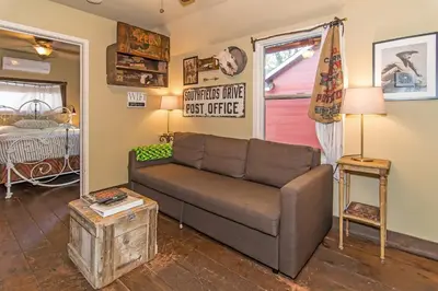 a living room with a couch and a bed at Miner's Camp in Foresthill