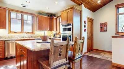 a kitchen with wooden cabinets and a center island at Gray Stone 2088 Holiday home in Mammoth Lakes