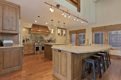 a large kitchen with wooden cabinets and a large island at Stonegate 5 Holiday home in Mammoth Lakes