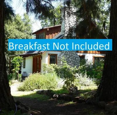 a house with a sign that reads breakfast not included at Yosemite Rose Bed and Breakfast in Groveland