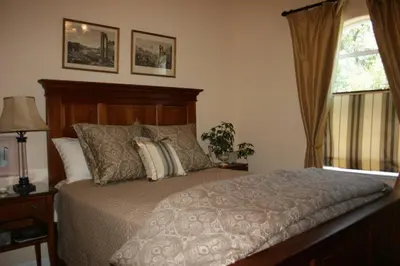 a bedroom with a bed and a window at Yosemite Rose Bed and Breakfast in Groveland