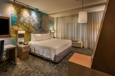 a hotel room with a bed and a flat screen tv at Courtyard by Marriott Reno Downtown/Riverfront in Reno