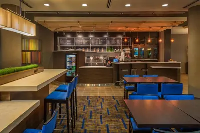 a restaurant with blue chairs and tables and a bar at Courtyard by Marriott Reno Downtown/Riverfront in Reno