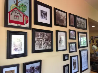 a wall full of pictures on a wall at Priest Station Cafe & Cabins in Groveland