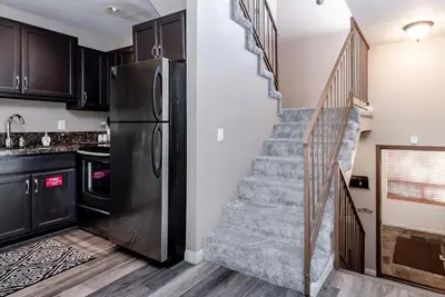 a kitchen with a staircase and a refrigerator at Chamonix # 88 in Mammoth Lakes