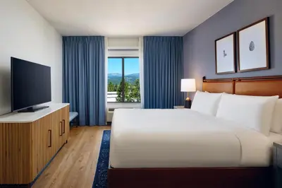 a bedroom with a large bed and a television at Martis Valley Lodge, Tapestry Collection by Hilton in Truckee