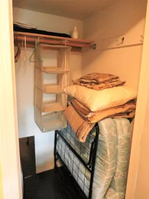 a closet with two bunk beds and folded clothes at Charming Downstairs Unit in Oakhurst