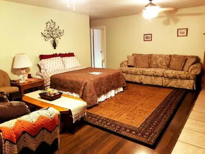 a living room with a bed and a couch at Charming Downstairs Unit in Oakhurst