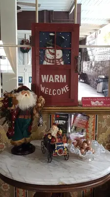 a figurine of santa claus and a toy car on a table at Gunn House Hotel in Sonora