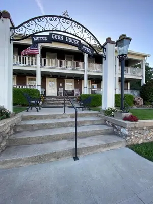 a building with stairs in front of a building at Gunn House Hotel in Sonora