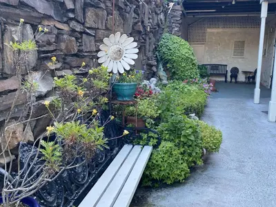 a bench with a bunch of flowers and plants at Gunn House Hotel in Sonora