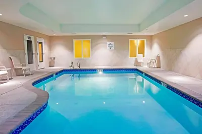 a pool with blue water in a hotel room at Holiday Inn Express Reno Airport by IHG in Reno