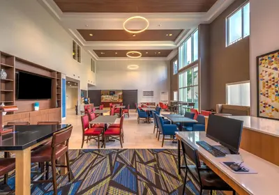 a lobby with tables and chairs and a cafeteria at Holiday Inn Express Reno Airport by IHG in Reno