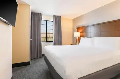 a hotel room with a large bed and a window at Staybridge Suites Reno Nevada by IHG in Reno