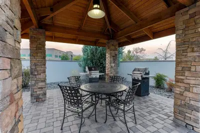 a patio with a table and chairs and a grill at Staybridge Suites Reno Nevada by IHG in Reno