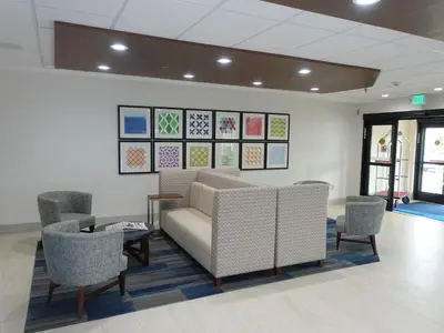 a waiting room with a couch and chairs in it at Holiday Inn Express & Suites Brentwood in Brentwood