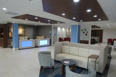 a lobby with a couch and chairs in a building at Holiday Inn Express & Suites Brentwood in Brentwood