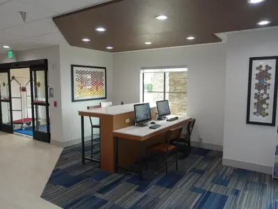 an office with two desks with computers on them at Holiday Inn Express & Suites Brentwood in Brentwood