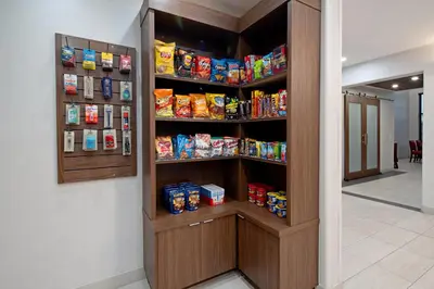 a hallway with a pantry with food on shelves at Holiday Inn Express Fresno South by IHG in Fresno
