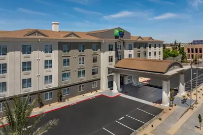 an image of ariott hotel with a large parking lot at Holiday Inn Express Fresno River Park Highway 41 by IHG in Fresno