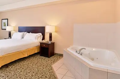 a hotel room with a bed and a bath tub at Holiday Inn Express Fresno River Park Highway 41 by IHG in Fresno