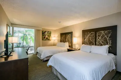 a hotel room with two beds and a window at Wyndham Garden Fresno Yosemite Airport in Fresno