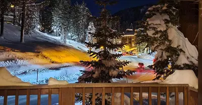 a view of a snow covered street at night at Village Treehouse #1 in Mammoth Lakes
