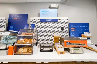a display of donuts on a counter in a store at Holiday Inn Express & Suites Sacramento NE Cal Expo by IHG in Sacramento