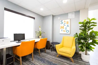an office with a desk and chairs and a computer at Holiday Inn Express & Suites Sacramento NE Cal Expo by IHG in Sacramento