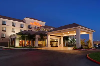 a hotel with a parking lot in front of it at Hilton Garden Inn Sacramento Elk Grove in Elk Grove