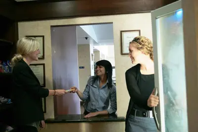 a woman standing in front of a mirror holding a toothbrush at Hampton Inn & Suites Lodi in Lodi