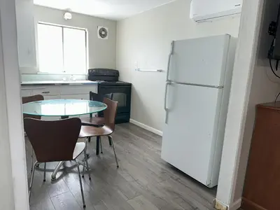 a kitchen with a table and a white refrigerator at Alpine Inn & Spa in South Lake Tahoe