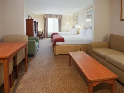 a hotel room with a bed and a couch at Holiday Inn Express Hotel & Suites Carson City by IHG in Carson City