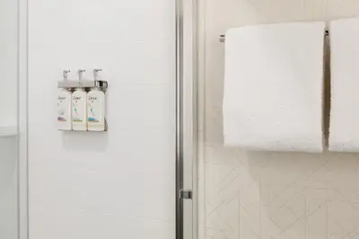 a bathroom with a shower and a towel at Holiday Inn Express Hotel & Suites Carson City by IHG in Carson City