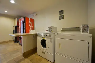 a laundry room with a washing machine and a counter at Holiday Inn Express Elk Grove West I-5 by IHG in Elk Grove