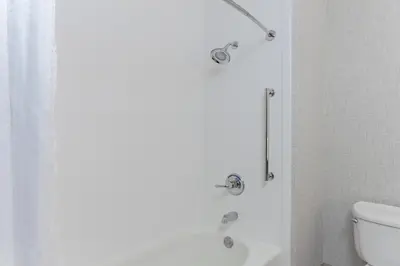 a bathroom with a shower with a toilet and a sink at Holiday Inn Express Elk Grove West I-5 by IHG in Elk Grove