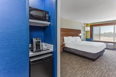 a hotel room with a bed and a tv at Holiday Inn Express Elk Grove West I-5 by IHG in Elk Grove