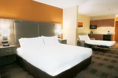 a large white bed in a hotel room at HOLIDAY INN EXPRESS & SUITES ELK GROVE CENTRAL - HWY 99 by IHG in Elk Grove